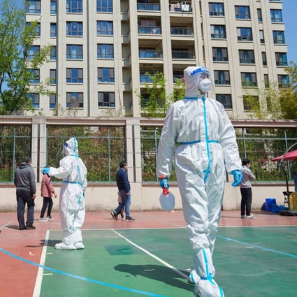Covid-19 pandemic prevention workers help residents take coronavirus tests in Shanghai. Photo: AFP