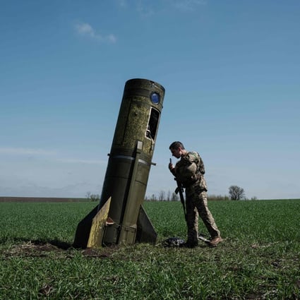 A Ukrainian serviceman inspects a part of a Russian ballistic missile booster that fell in a field in Bohodarove, eastern Ukraine. Photo: AFP