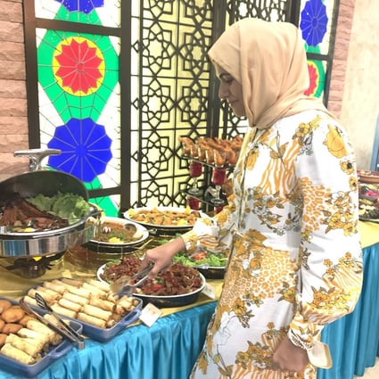 The writer’s neighbour in Kuala Lumpur, Malaysia, Sajida Aziz Omar, breaks her daily Ramadan fast at an Iftar buffet. Omar says dry fasting - consuming no food or water for 13-plus hours - gives her more energy. Photo: Lise Floris