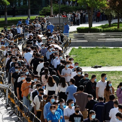 People line up outside a makeshift nucleic acid testing site during a mass Covid-19 detection programme in Haidian district of Beijing on Tuesday. Photo: Reuters