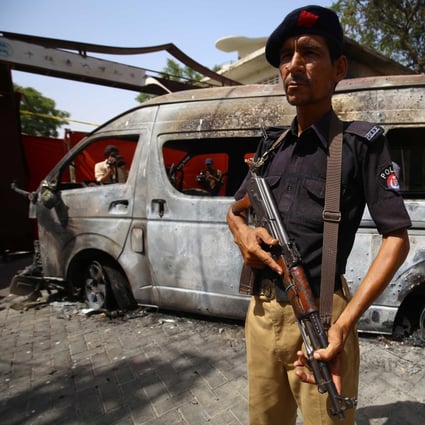Pakistani security officials at the site of a suicide attack in Karachi. Photo: EPA-EFE