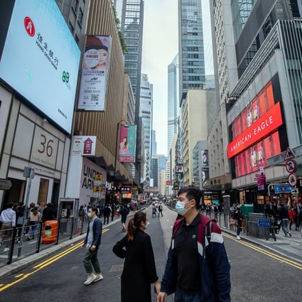 Pedestrians cross Queen’s Road Central in the Central district of Hong Kong on January 24, 2022. Photo: Bloomberg.