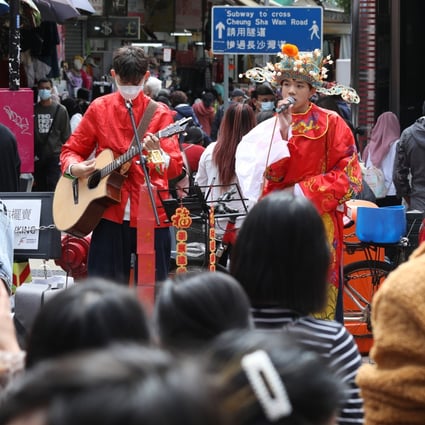 A man dressed as the God of Wealth sings on the street in Sham Shui Po in late January. Photo: Yik Yeung-man