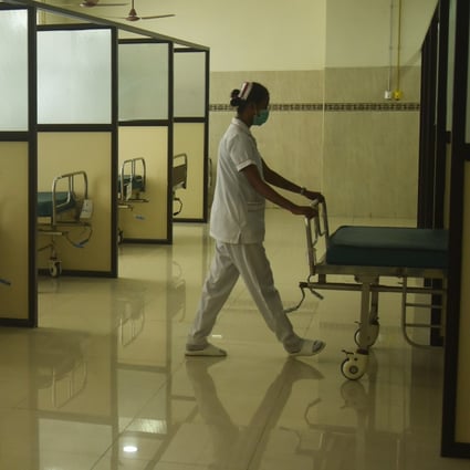 A health worker arranges a bed inside a Covid-19 ward amid a rise in cases, at a government hospital in Chennai, India in April. Photo: EPA-EFE