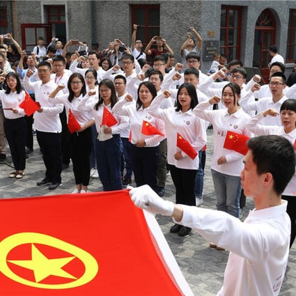 Students from Peking University recite the joining oath of the Communist Youth League in Beijing. Photo: China Daily