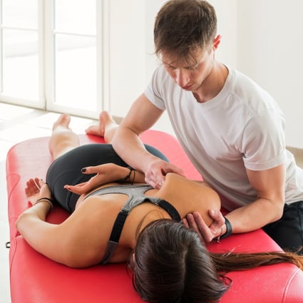 An osteopath performs a scapula myofascial massage on a woman. Keeping the fascia, the body’s largest organ, working smoothly helps ensures pain-free movement as we age. Photo: Shutterstock