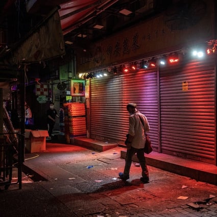 A man walks past a closed shop in Hong Kong on April 30. Falling growth figures could be a harbinger of continuing weakness. Photo: Bloomberg