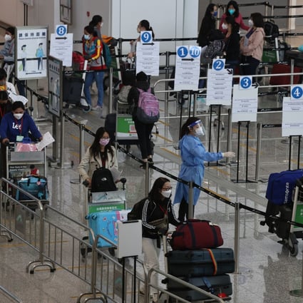 Passengers queue at Hong Kong International Airport. Photo: K. Y. Cheng