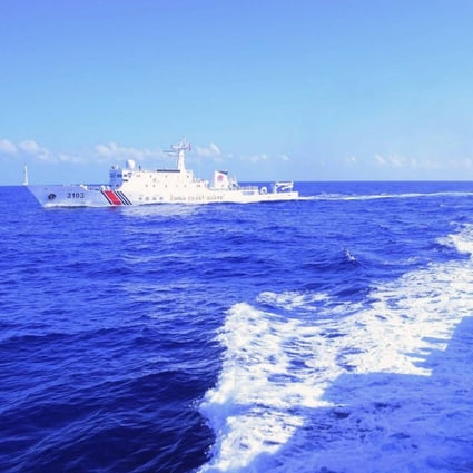 A Philippine coast guard member monitors a Chinese coast guard ship in South China Sea on March 27. Photo: Philippine Coast Guard/AFP 