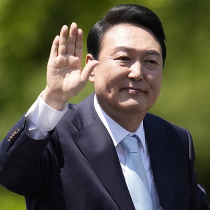South Korea’s new President Yoon Suk Yeol waves from a car after the Presidential Inauguration outside the National Assembly in Seoul, South Korea, on Tuesday. Photo: AP Photo