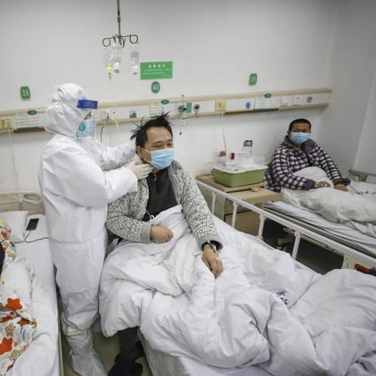A doctor checks on patients at Wuhan’s Jinyintan Hospital, designated for critical Covid-19 patients, during the early days of the pandemic in February 2020. Photo: AP 