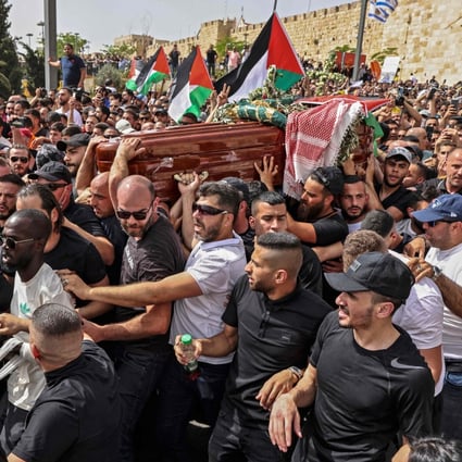 Palestinian mourners carry the casket of slain journalist Shireen Abu Akleh from a church to the cemetery in Jerusalem on Friday. Photo: AFP