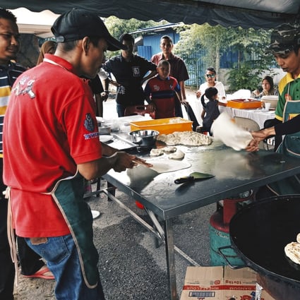 A vendor prepares roti canai terbang at a stall in Malaysia. The Indian flatbread, served griddled and often eaten with curry and sambal, is ubiquitous in hawker centres across Singapore and Malaysia. Photo: Shutterstock