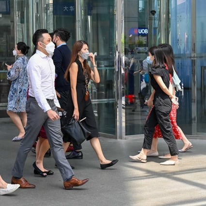 Office workers walk out for a lunch break in the financial business district in Singapore on May 10, 2022. ADDX claims its offering makes private equity more accessible to individual investors. Photo: Agence France Presse