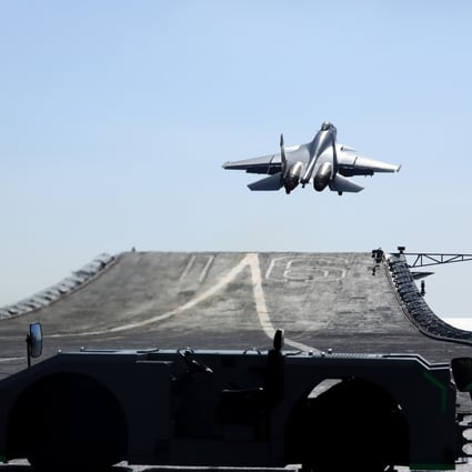 A carrier-based J-15 fighter jet takes off from the Liaoning’s flight deck during open-sea combat training. Photo: Xinhua