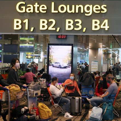 Travellers sit as they wait to embark at the Changi Airport in Singapore in March. Photo: Reuters