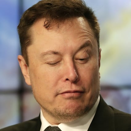 Elon Musk jokes with reporters as he pretends to search for an answer to a question on a mobile phone during a news conference at the Kennedy Space Centre in Cape Canaveral, Florida, in January 2020. Photo: AP