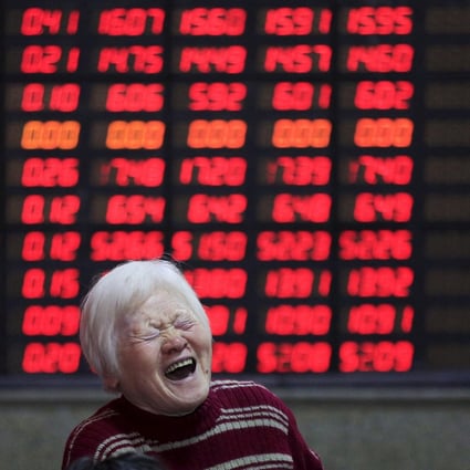 An investor at a brokerage house in Shanghai on March 7, 2016. Contrary to global conventions, China’s stock market represents gains and advances in red, using the green colour to denote losses and declines. Photo: Reuters
