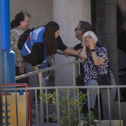 A first responder grief counselor comforts a parishioner after a person opened fire during a church service attended by a Taiwanese congregation in Laguna Woods, Southern California. Photo: TNS