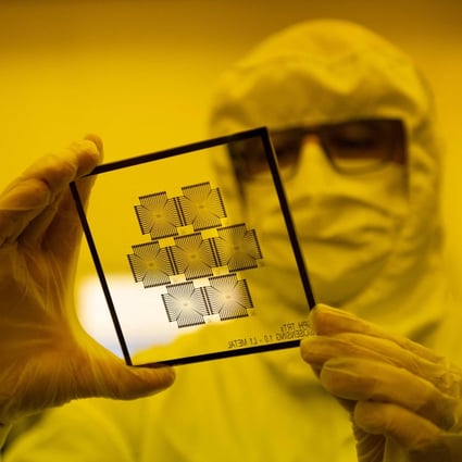 An employee inspects chips in the clean room of the Barcelona Institute for Microelectronics, March 3, 2022. - Photo: AFP