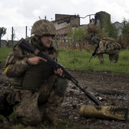 Ukrainian servicemen on patrol in a recently retaken village, north of Kharkiv, east Ukraine. Photo: AP