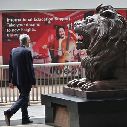 A pedestrian walks past the HSBC headquarters in Hong Kong on April 26, as the bank releases first quarter results. Photo: AFP
