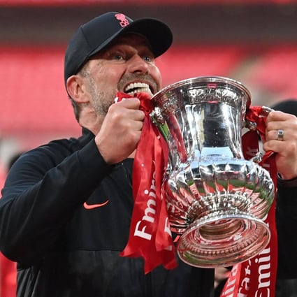 Liverpool manager Jurgen Klopp celebrates with the trophy after winning the English FA Cup final football match at Wembley stadium. Photo: AFP