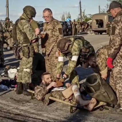 Russian servicemen frisk Ukrainian fighters evacuated from the besieged Azovstal steel plant in Mariupol, on Tuesday. Photo: Russian Defence Ministry Handout via EPA-EFE