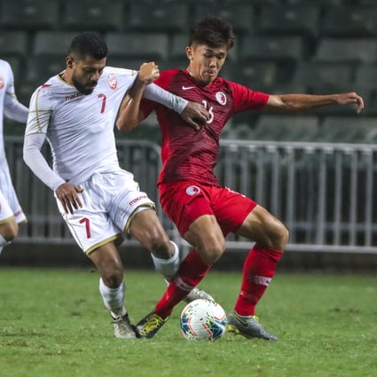 Tan Chun-lok (red) vies for the ball during the 2022 Soccer World Cup Qualifiers Asian Zone at Hong Kong Stadium. Photo: May Tse