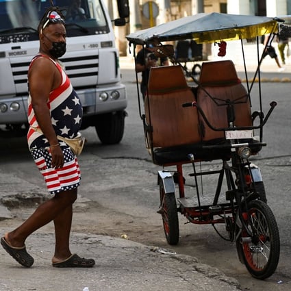 A man in Havana, wearing a T-shirt and a shorts with the US flag. Photo: AFP