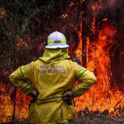 A New South Wales (NSW) Rural Fire Service volunteer watches a fire in bushland during back-burning operations in bushland near the town of Kulnura, New South Wales, Australia in December 2019. Photo: Bloomberg