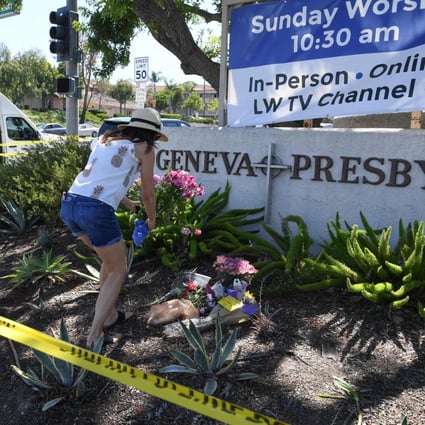 A woman places flowers at a makeshift memorial outside the Geneva Presbyterian Church on Monday. One person was killed and five were wounded in a shooting at the church in Laguna Woods, California on Sunday. Photo: AFP