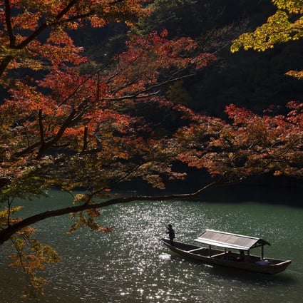 A sightseeing boat carries tourists on the Oi River at Arashiyama, one of Kyoto’s most popular tourist destinations, in Japan. Photo: Buddhika Weerasinghe/Getty Images