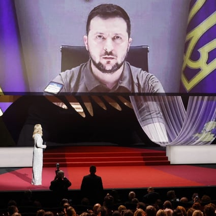 Ukraine’s President Volodymyr Zelensky is seen on a screen as he delivers a video address at the 75th Cannes Film Festival opening ceremony on Tuesday. Photo: Reuters
