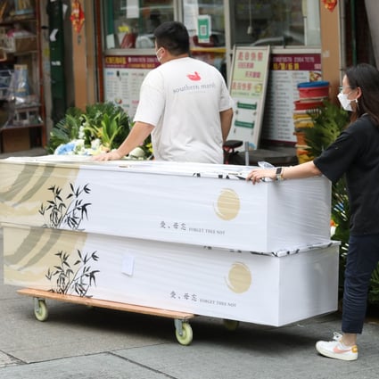 Workers transfer a coffin outside a funeral services shop in Hung Hom district in Hong Kong on March 16. Photo: Yik Yeung-man
