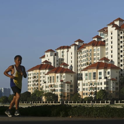 A man jogs past a condominium at Tanjong Rhu in Singapore. Photo: Reuters