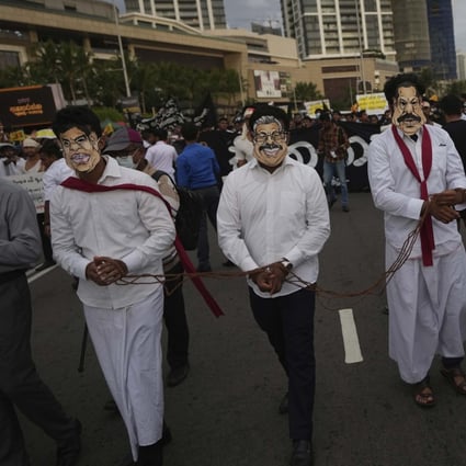 Sri Lankan protesters wear masks of president Gotabaya Rajapaksa’s family members during a march demanding Gotabaya resign. File photo: AP