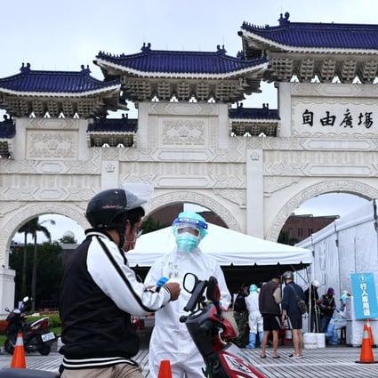 People line up to get a coronavirus test at a drive-through site at Liberty Square in Taipei on Friday. Photo: Reuters