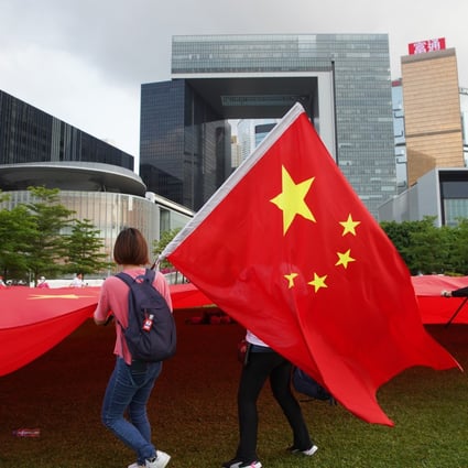 People display the national flag in Hong Kong in support of political reforms in 2021. Photo: Winson Wong