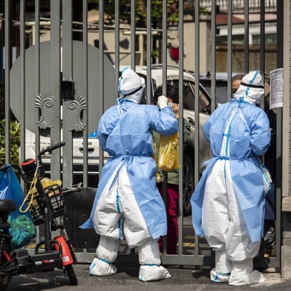 Healthcare workers collect swab samples from locked down residents in Shanghai on May 18, 2022. Photo” Bloomberg