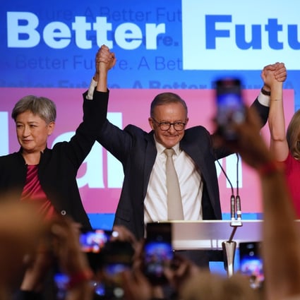 Labor Party leader Anthony Albanese (centre) celebrates with his partner partner Jodie Haydon, (right) and Labor senate leader Penny Wong at a Labor Party event in Sydney on Sunday. Photo: AP