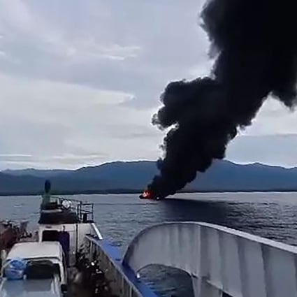 Black smoke rises from the burning ferry. Photo:  Kycel Pineda / AFP