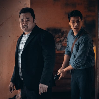 Ma Dong-seok (left) plays the police officer Don Lee, and Choi Gwi-hwa plays captain Jeon Il-mann a still from The Roundup.
