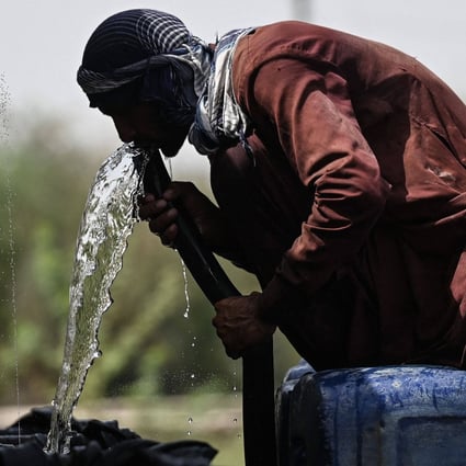 A man drinks water from a pipe in Jacobabad earlier this month amid the intense heatwave sweeping Pakistan and India. Photo: AFP