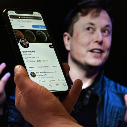 A smartphone displays the Twitter account of Elon Musk with a photo of him shown in the background in this illustration photo taken April 14. Photo: AFP