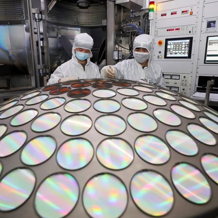 Employees work on the semiconductor chip production line in a factory in Huaian, Jiangsu province. Photo: China Daily