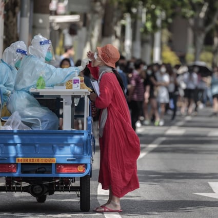 A woman takes a PCR test on an improvised mobile testing booth made from a cargo motorcycle in Shanghai. Photo: EPA-EFE