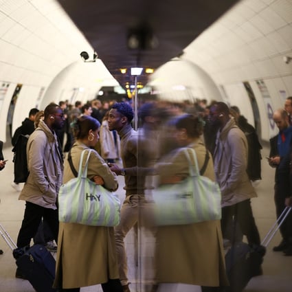 Passengers board an Elizabeth Line train at Liverpool Street underground station. Photo: Reuters