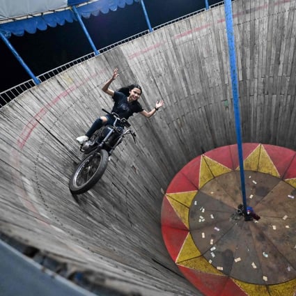 Daredevil Karmila Purba rides the Wall of Death at a night carnival in Bogor, Indonesia. Photo: AFP