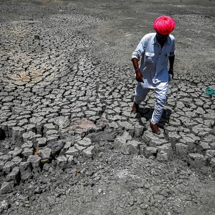A villager walks through a dried-up pond during India’s early heatwave. Photo: Getty Images
